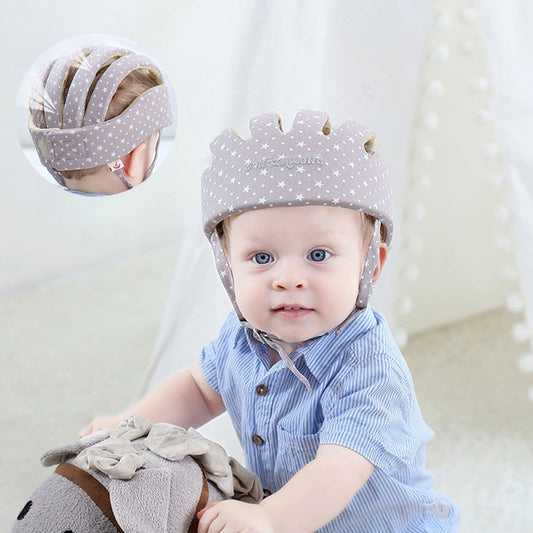 Baby wearing grey polka dot toddler helmet head protector