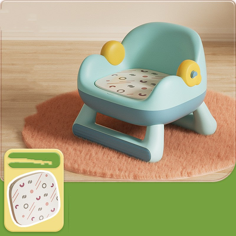 Children's learning chair with wheels on a wooden floor.