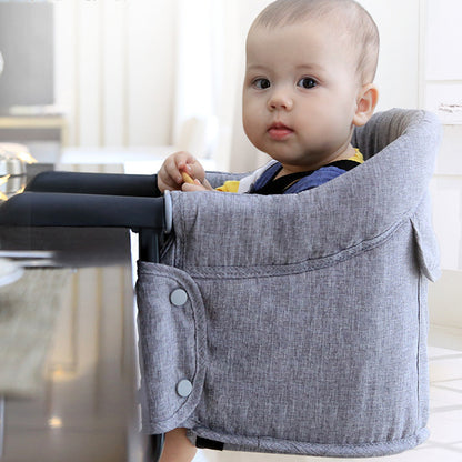 Baby in a gray Portable High Chair