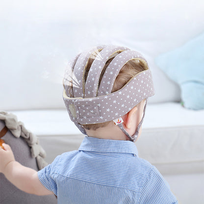 Back view of baby wearing grey star print toddler helmet