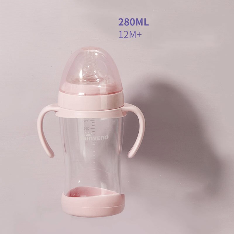 Baby holding pink feeding bottle with handles independently