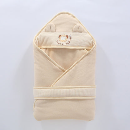 Newborn wrapped snugly in soft cotton swaddle wrap