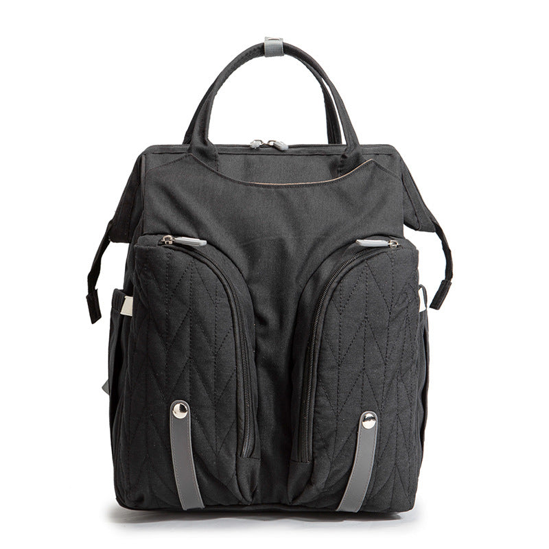 Diaper bag backpack flat lay with changing mat and stroller straps