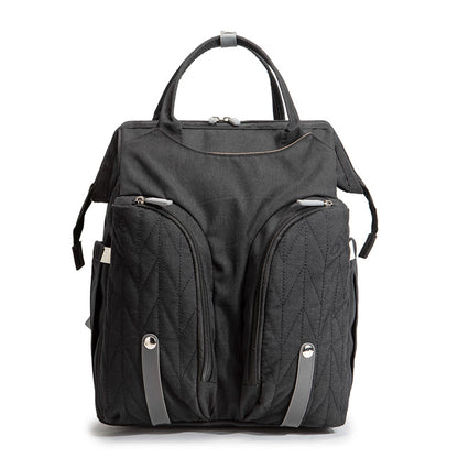 Diaper bag backpack flat lay with changing mat and stroller straps