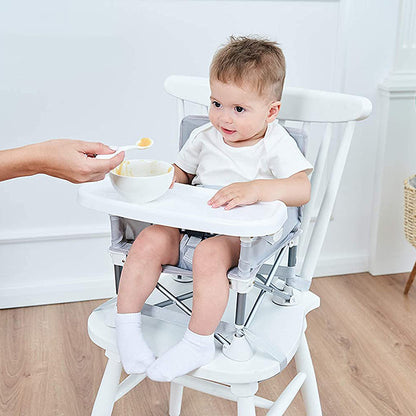 Portable high chair booster seat on dining chair