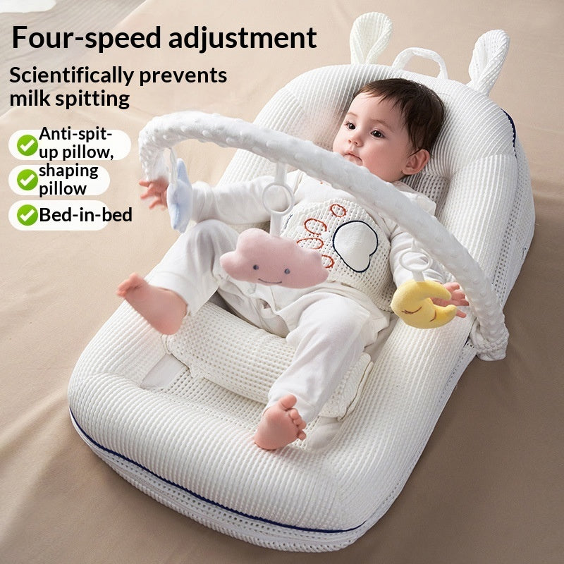 Portable newborn bed with soft padded sides and adjustable incline pillow