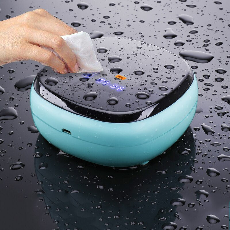 Wiping down the rechargeable breast pump control unit with a cleaning wipe.
