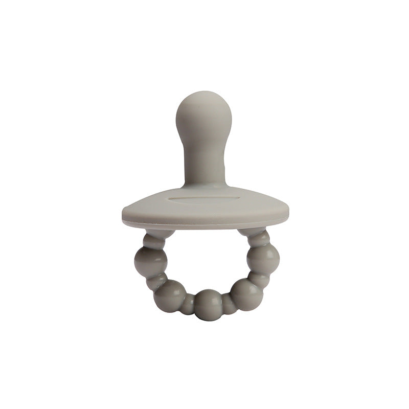 One piece pacifier held up to show smooth silicone shield