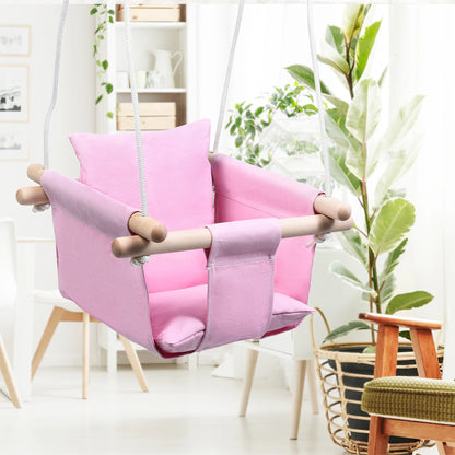 Pink children's swing chair in a room with a toddler swing seat