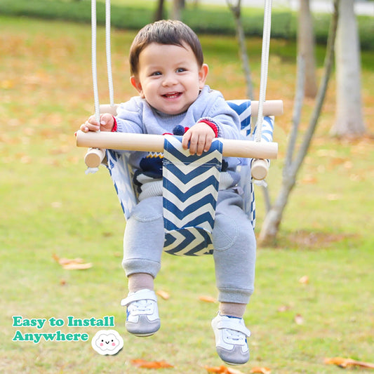 A child sitting on a tree swing for baby 